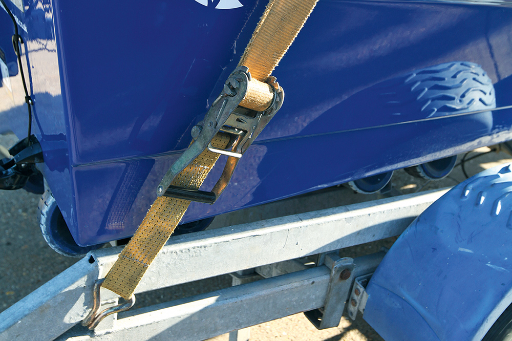 Rachet straps securing a boat to the trailer