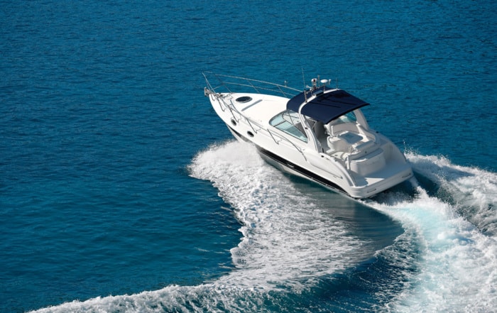 White motorboat making waves on blue water