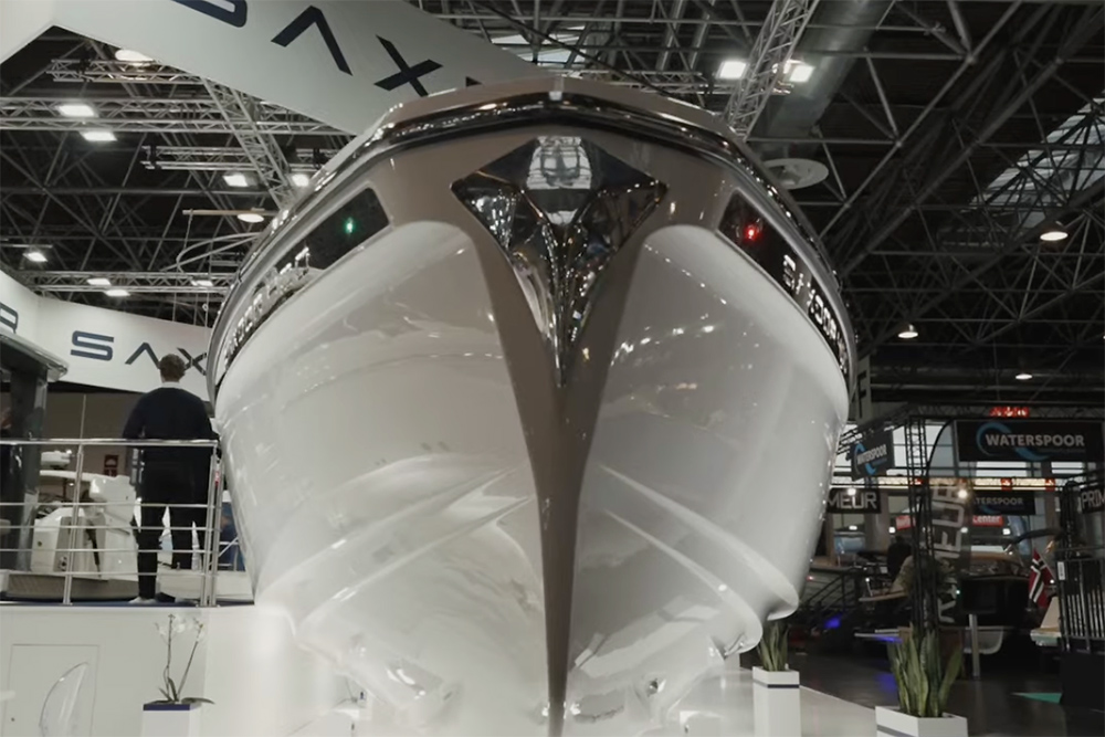 Bow view of Saxdor 400 GTC on display at boot Dusseldorf boat show with Saxdor signage on ceiling behind
