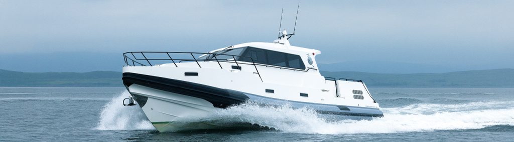 Dromquinna Redbay 1150 RIB underway at sea with white spray