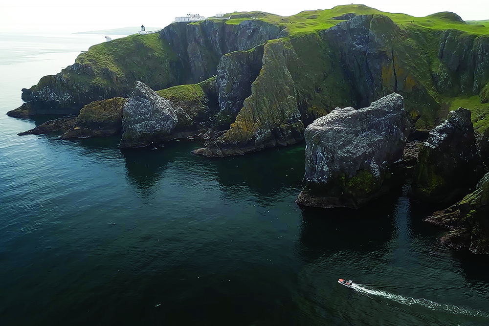 Goodwin passing beneath steep sea cliffs