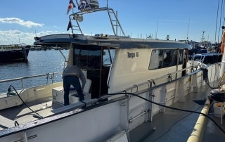 boat next to fuel pontoon filling up with fuel