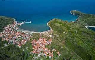 Part of the coastline of Lošinj island with clean green and blue seas.