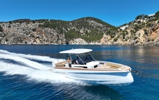 STERK boat voyaging past land.