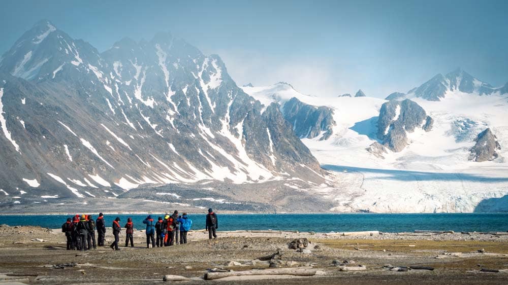 Arctic Expedition Micro Cruises from Secret Atlas. People hiking with beautiful scenery and moutains in Svalbad Secret Atlas