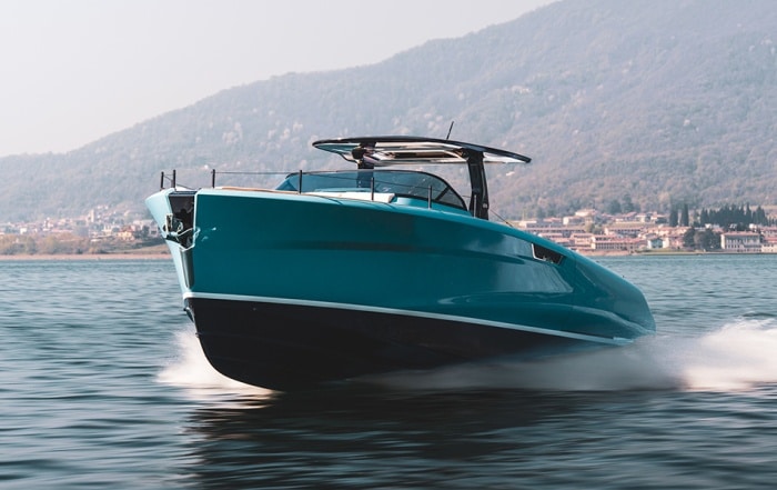 Astor 36 voyaging across the water with land in the background.