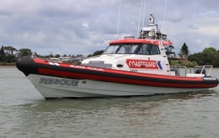 A modern Coastguard rescue RIB is seen on calm waters.
