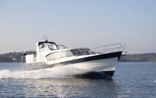 The Hardy 45 European voyaging on water with land in the background.