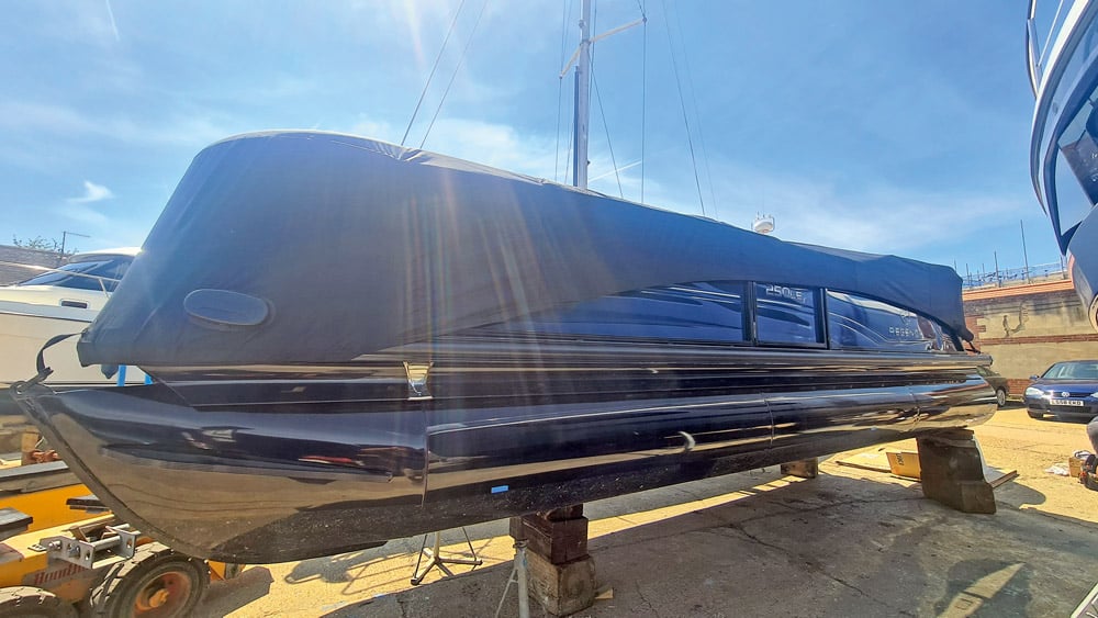 Regency 250 LE3 Sport Pontoon Boat. The tonneau can be tightened drum-tight for towing.