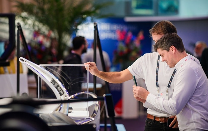 Two men examine a marine product display at Metstrade.