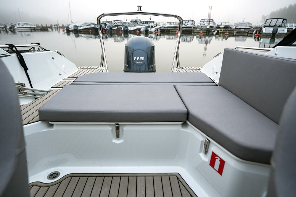 Yamarin - The aft sofa folds flat to make a sunbed.