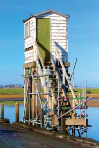 Weathered wooden refuge on the causeway