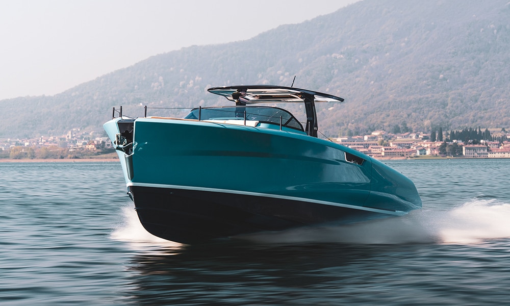 Astor 36 voyaging across the water with land in the background.