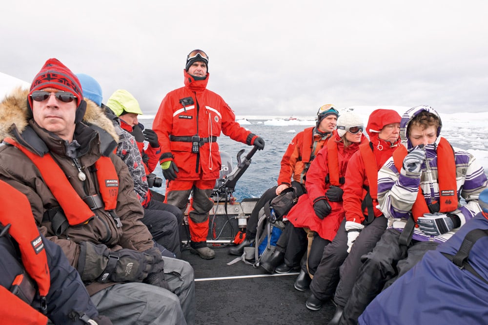 A busy tourist boat tour on Antarctica at Paradise bay. © iStock-cunfek