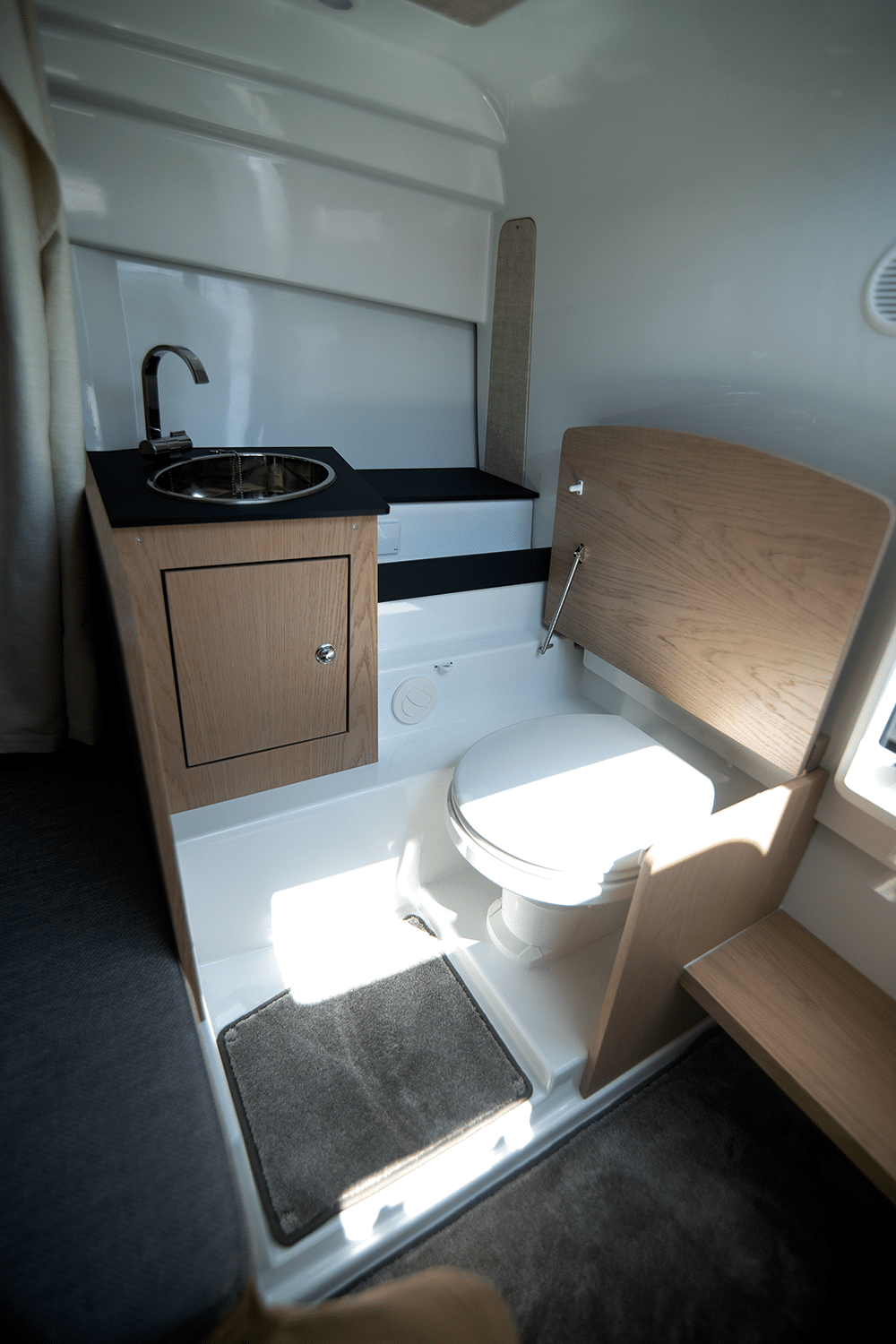 The toilet can be separated by a curtain.