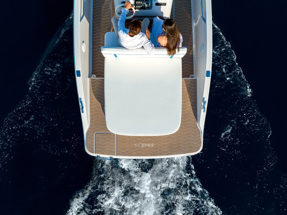Aft deck with sun lounger and swim ladder.