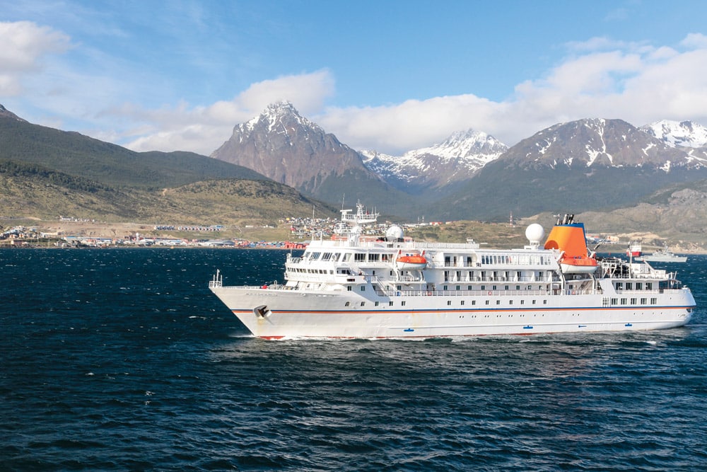 Expedition boat motors into Ushuaia harbour, Tierra del fuego, Argentina © Simon KR/istockphoto