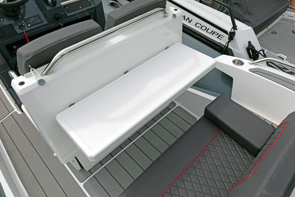 Fold down table to reverse side of helm seat.