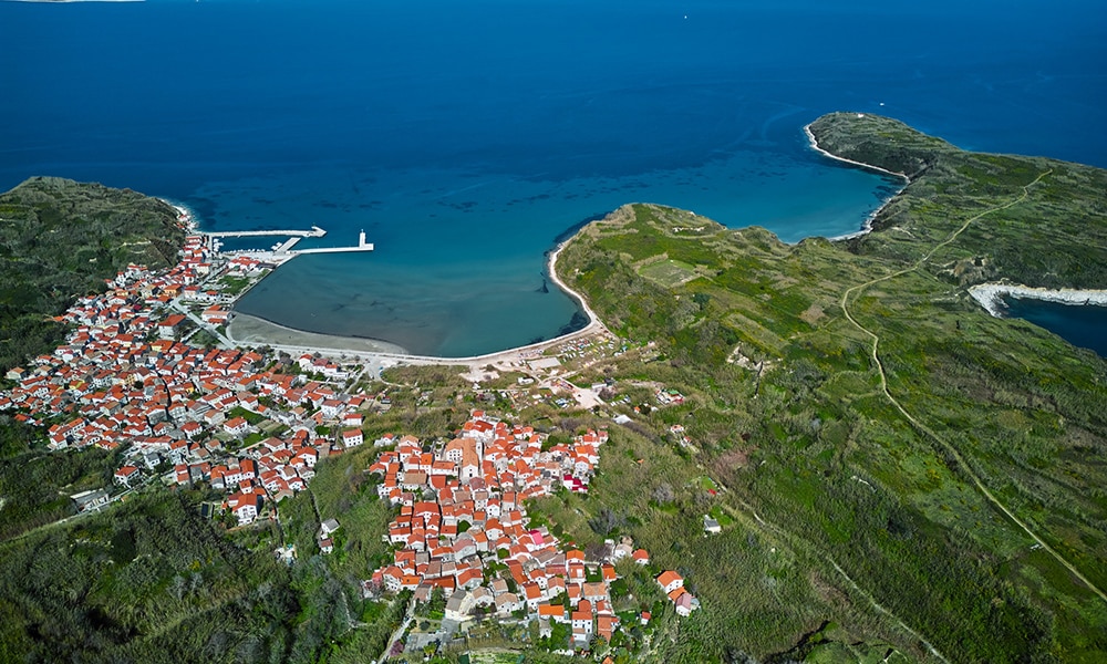 Part of the coastline of Lošinj island with clean green and blue seas.