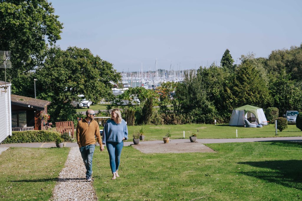 Couple walking through glamping campsite