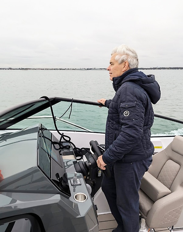 Man stood at the wheel driving a Nordkapp boat