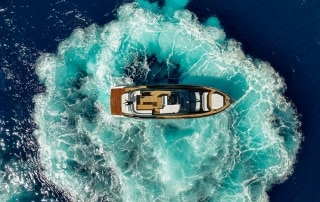 Sessa Marine's F60 performing a high-speed turn, creating a circular wake in vivid blue water, viewed from directly above.