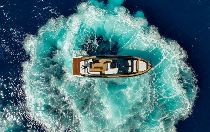 Sessa Marine's F60 performing a high-speed turn, creating a circular wake in vivid blue water, viewed from directly above.
