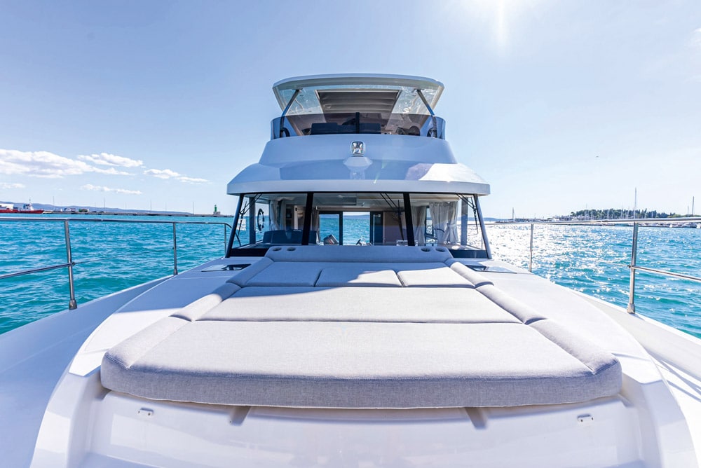 Optional sun pad with lift-up sections creates the vessel’s forward seating