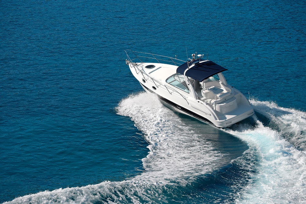 White motorboat making waves on blue water