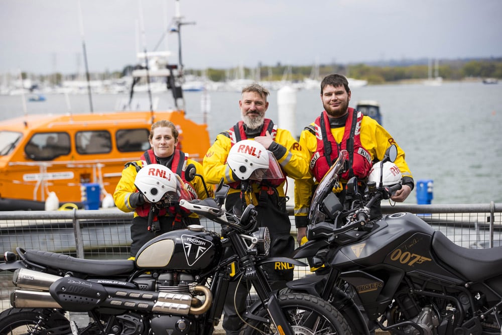 RNLI volunteer crew members from Largs, Clovelly and Minehead with the motorbikes donated by Daniel Craig.