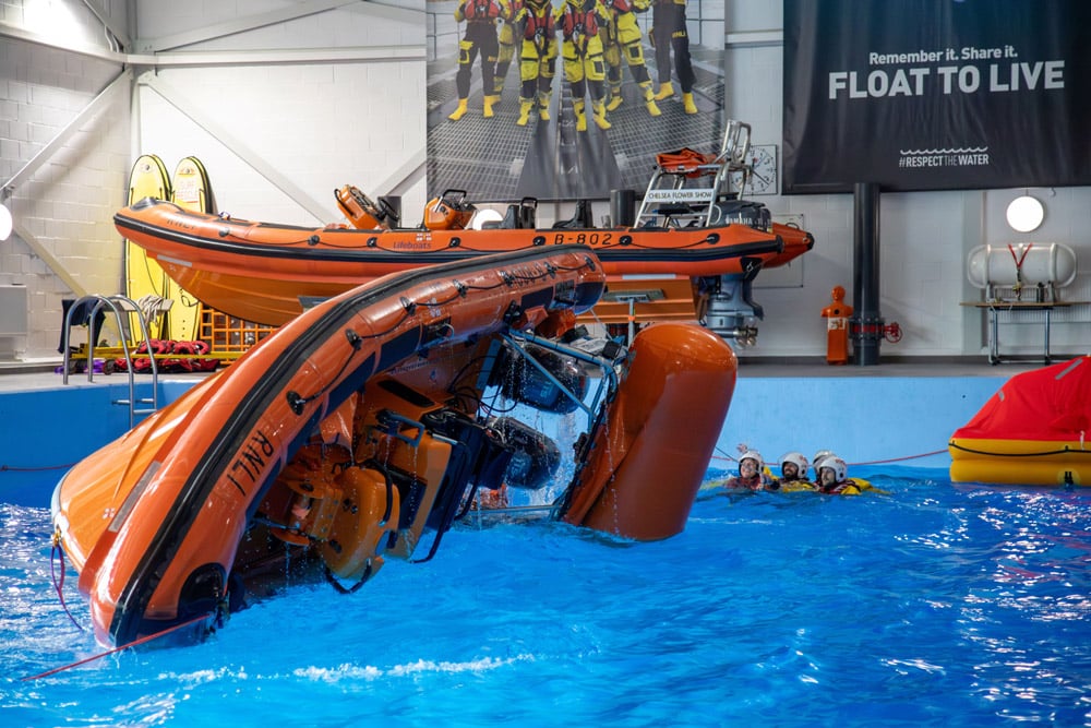 A demonstration of a lifeboat capsize in the sea survival pool at the RNLI College during the festival weekend