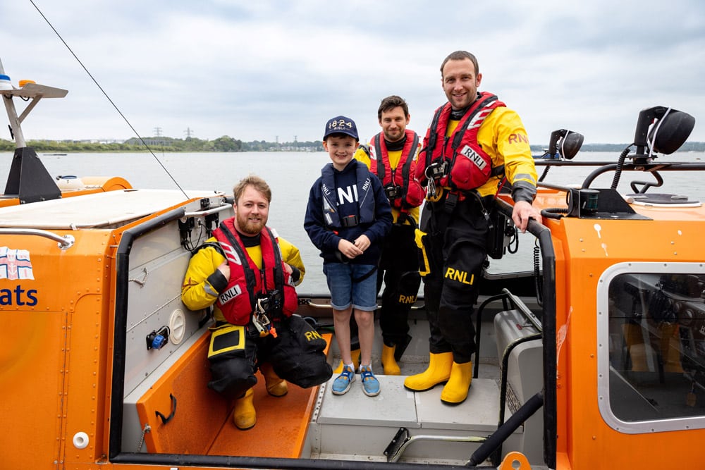 Young supporter Barnaby steps aboard an inshore rescue hovercraft.
