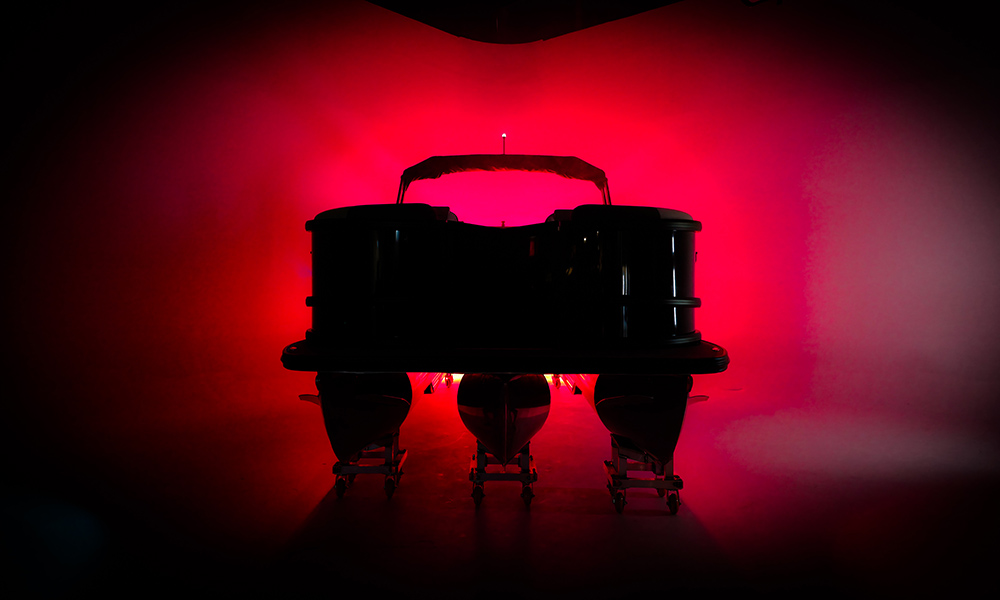 Alera Model M pontoon boat under dramatic red lighting.
