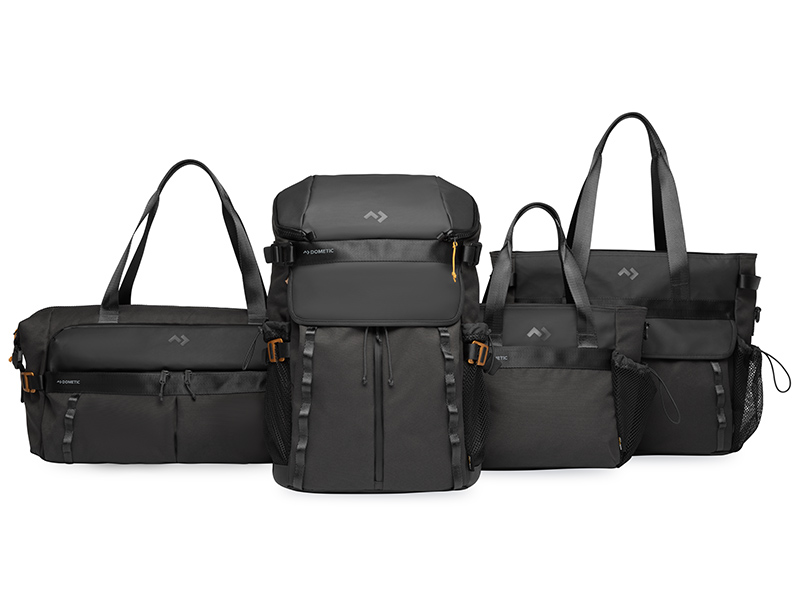 Dometic Unrestricted collection of black insulated travel bags and soft coolers including tote, backpack, and duffel styles.