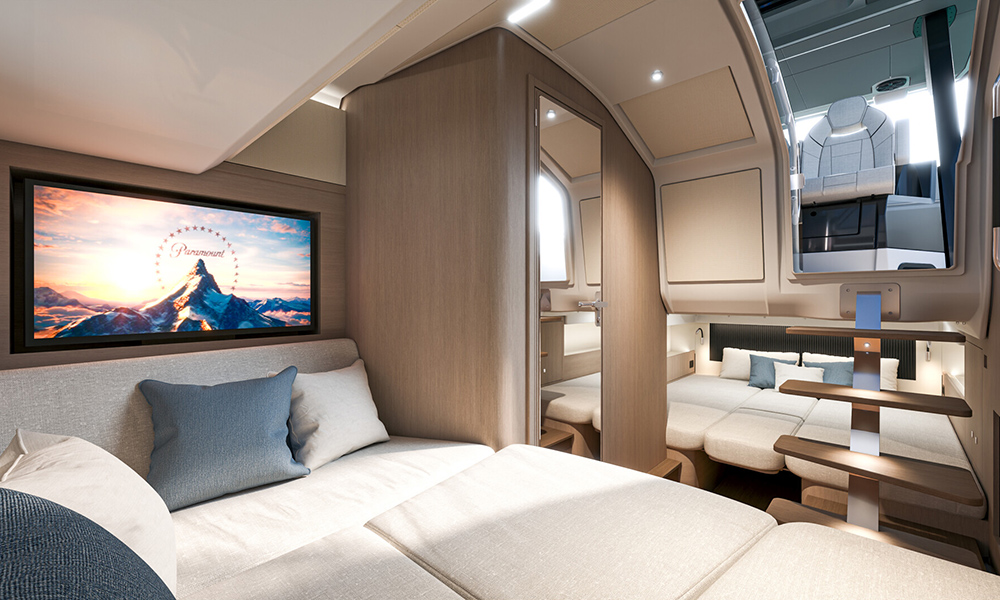 Gran Turismo 35 cabin with light wood finish, twin berths, TV screen and soft ambient lighting beneath the cockpit stairs.