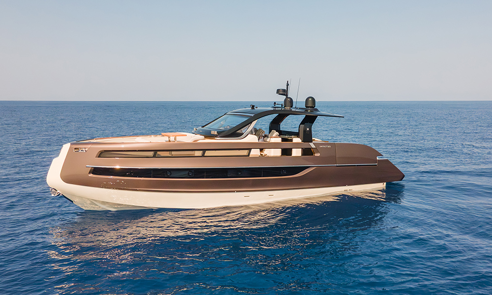 Invictus Yacht's TT550 at anchor in calm blue sea.