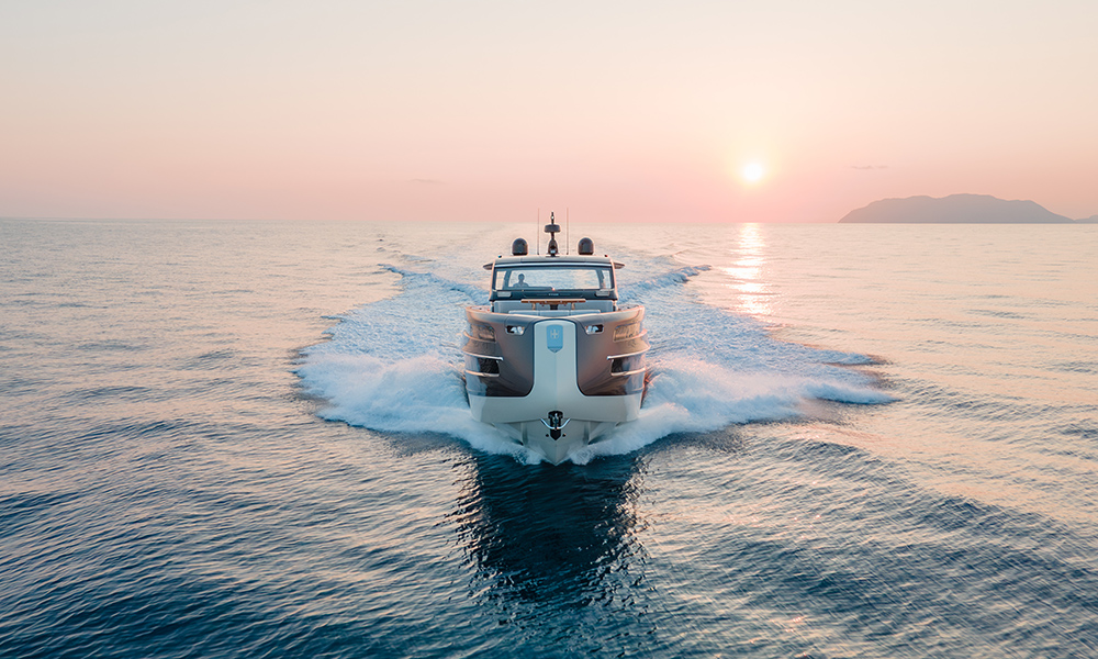 Invictus Yacht's TT550 cruising at speed at sunset.