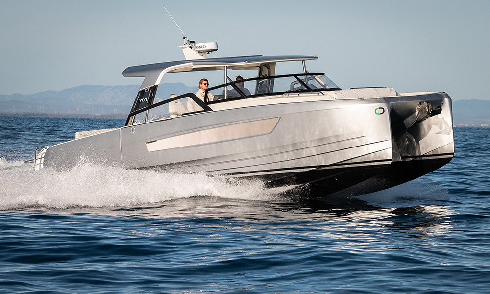YOT36 power catamaran cruising at speed on open water.