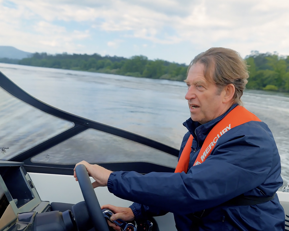 Man at the helm driving Bayliner boat