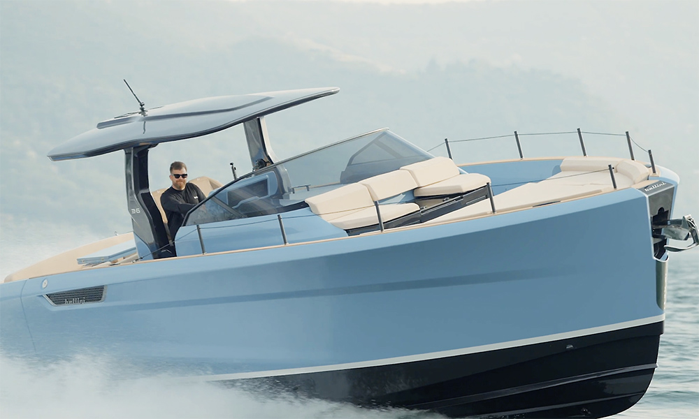 blue sports cruiser, bellini Astor 36, punching through the sea towards teh camera