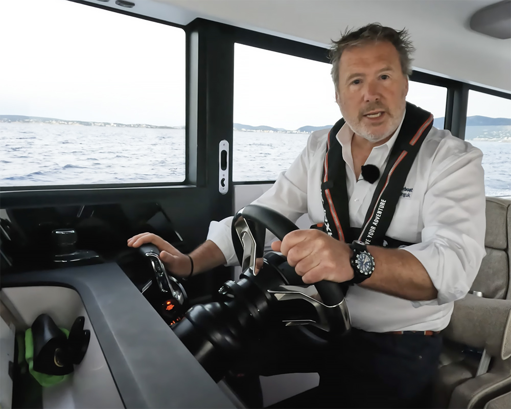 skipper at the helm of a Axopar powerboat