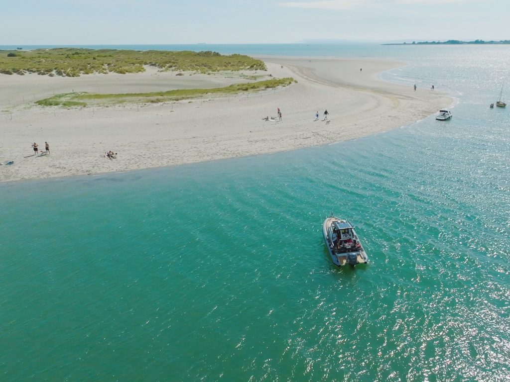 Image of boat moored off beautiful beach at East Head, Chichester