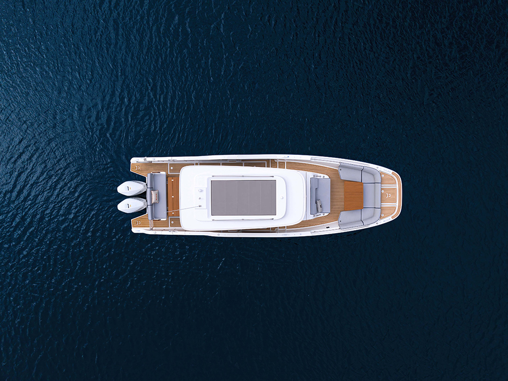 Top view of Aiata Wayfinder 38 yacht on open water, showing modular deck layout, sunpads, seating areas, and twin outboard engines.