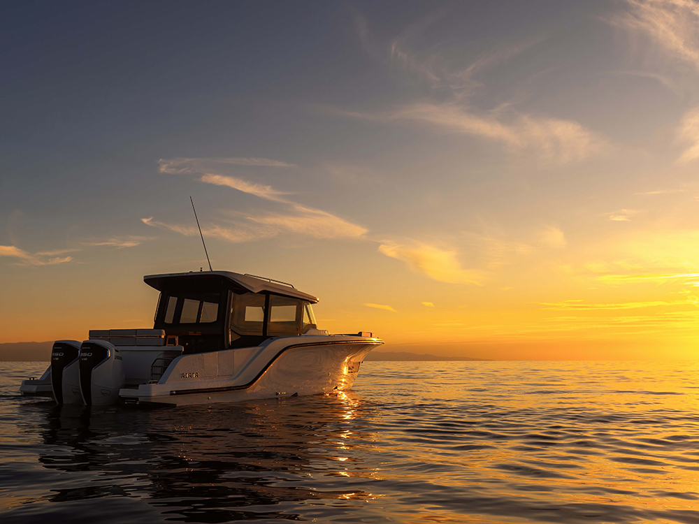 Aiata Wayfinder 38 motor yacht on calm water at sunset.