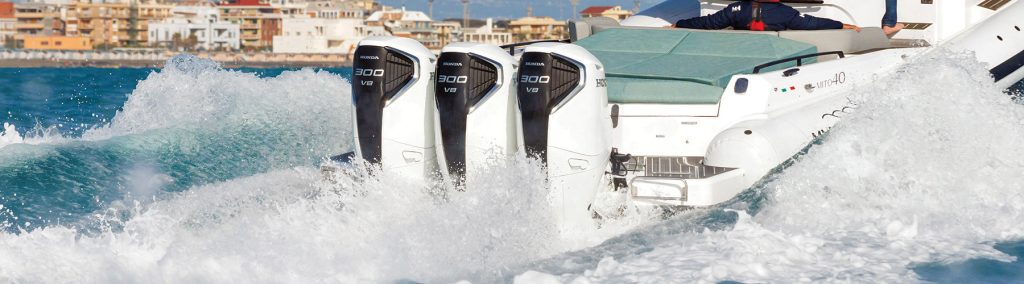 3 Honda outboard engines on stern of boat underway moving forwards away from camera