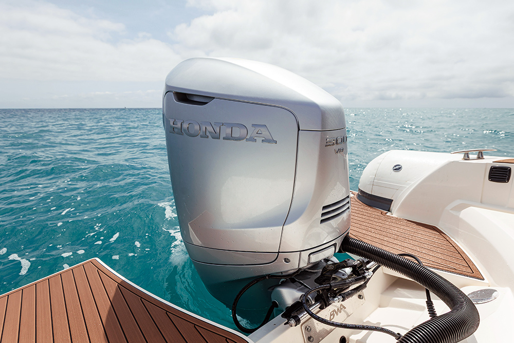 silver outboard withg tuquoise sea behind