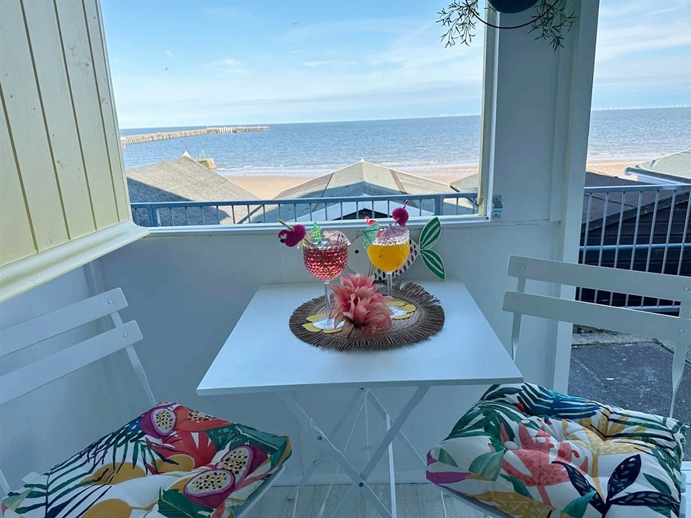 Cosy beach hut balcony with sea view.