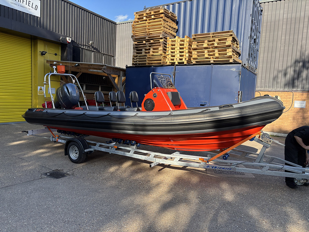 Custom Red and black XS 700 RIB on trailer.