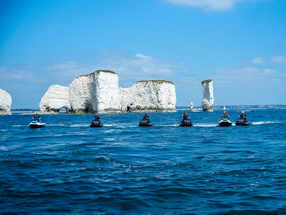 Riders on Sea-Doo watercraft exploring the Jurassic Coast.