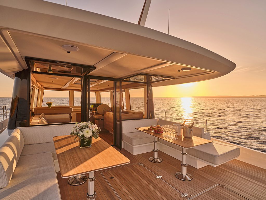 Omikron’s OT-60 aft deck lounge at sunset with ocean views.